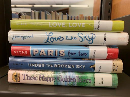 Book spines say: Love, love, love like sky, Paris for two, under the broken sky, these happy golden years