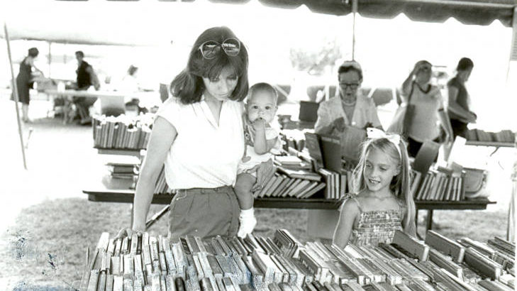 A photograph of the booksale on the lawn of McCollough Branch Library in 1983.