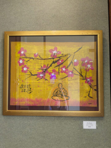 Framed painting features a yellow background with a branch of pink cherry blossoms extending across the canvas. Includes a simple line drawing of a meditating figure and Chinese characters on the left side, blending themes of nature and mindfulness.
